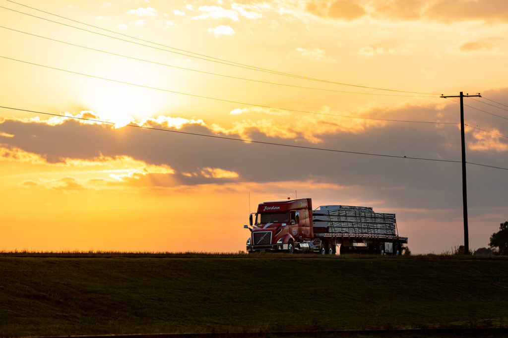 An American long-haul truck on the open road at sunset